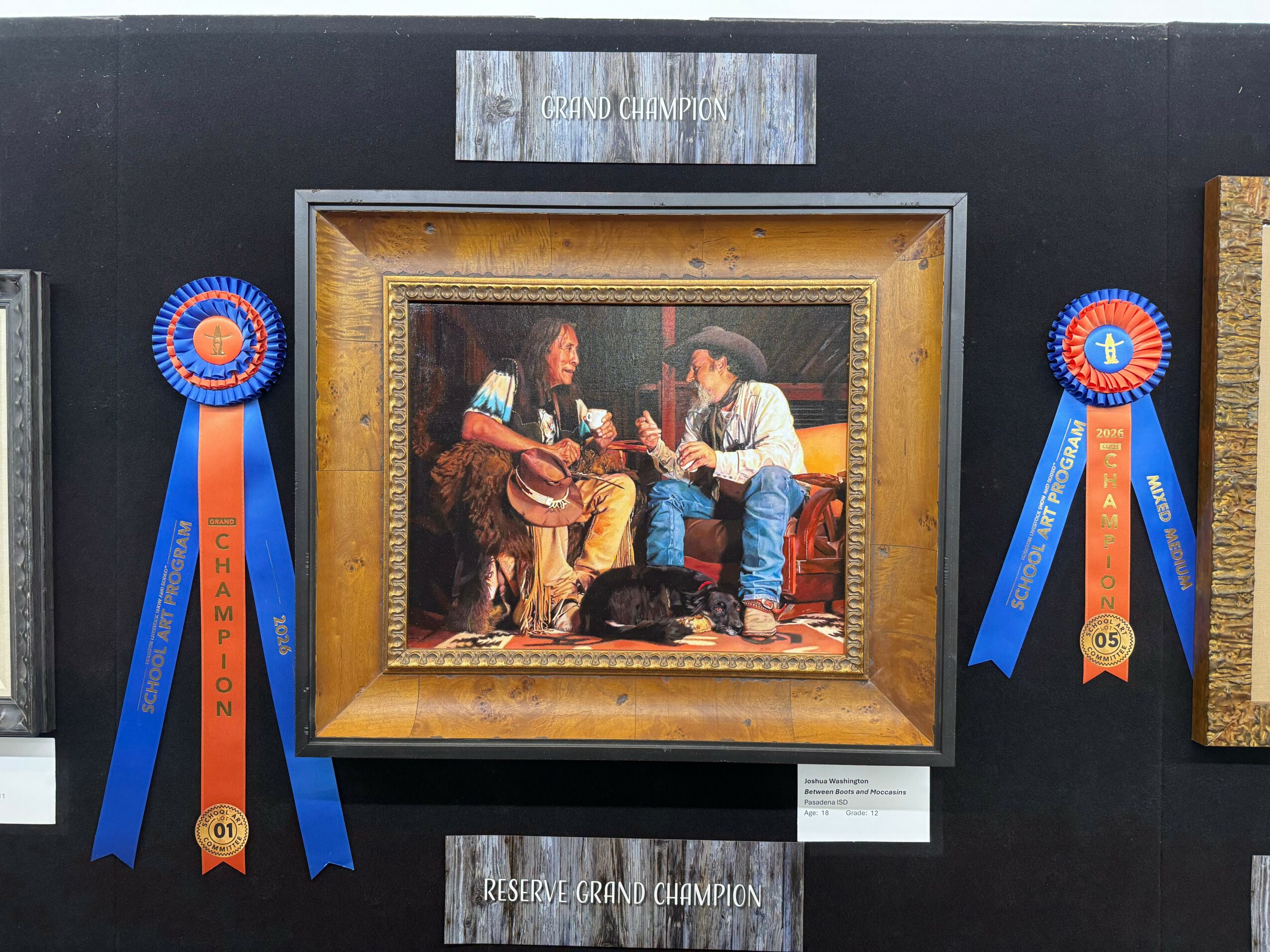 Painting of two people sitting and talking, with ribbons on each side, displayed on a black wall.