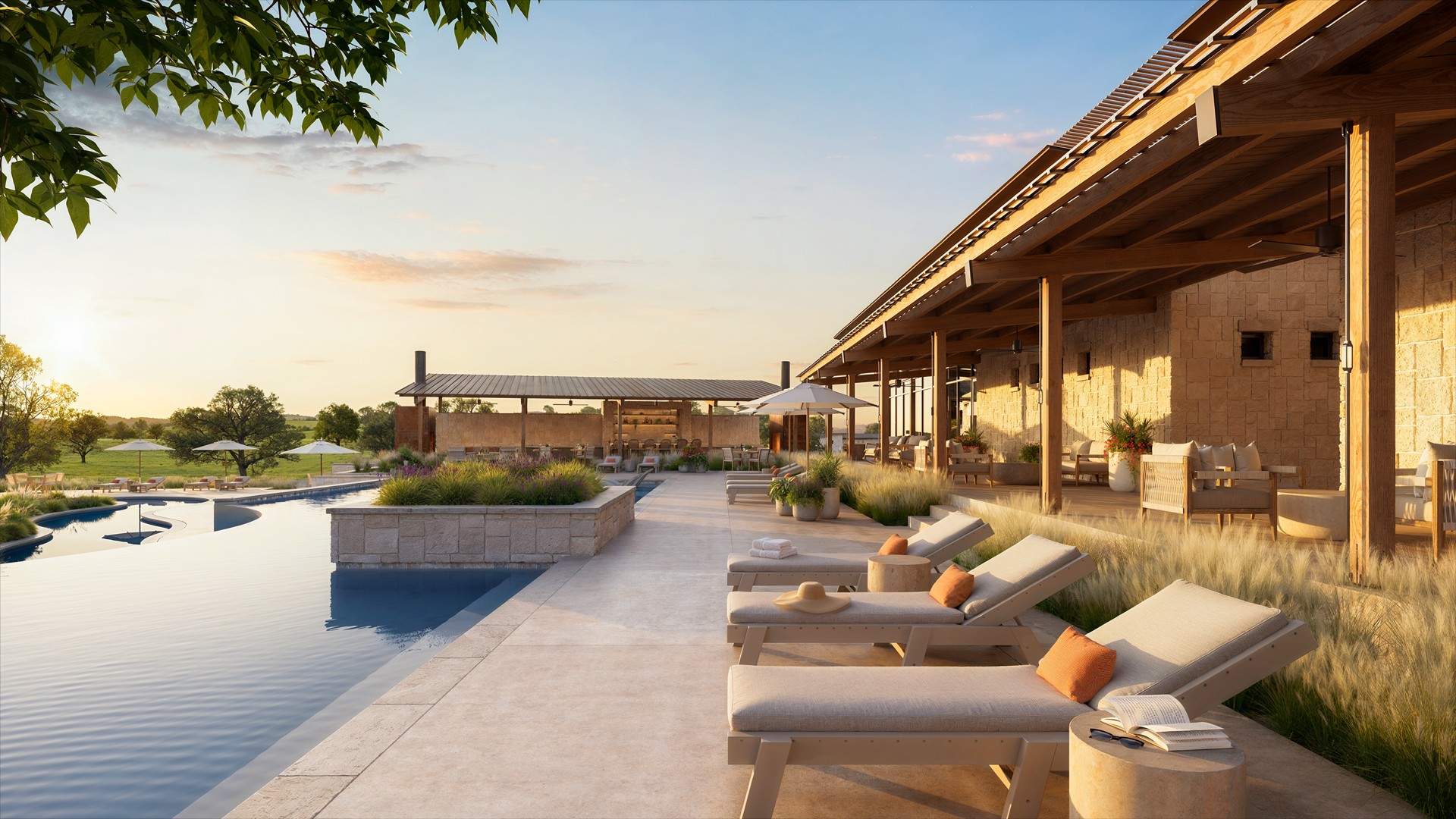 Outdoor pool area with lounge chairs, a modern building, and a clear sky, during sunset or sunrise.