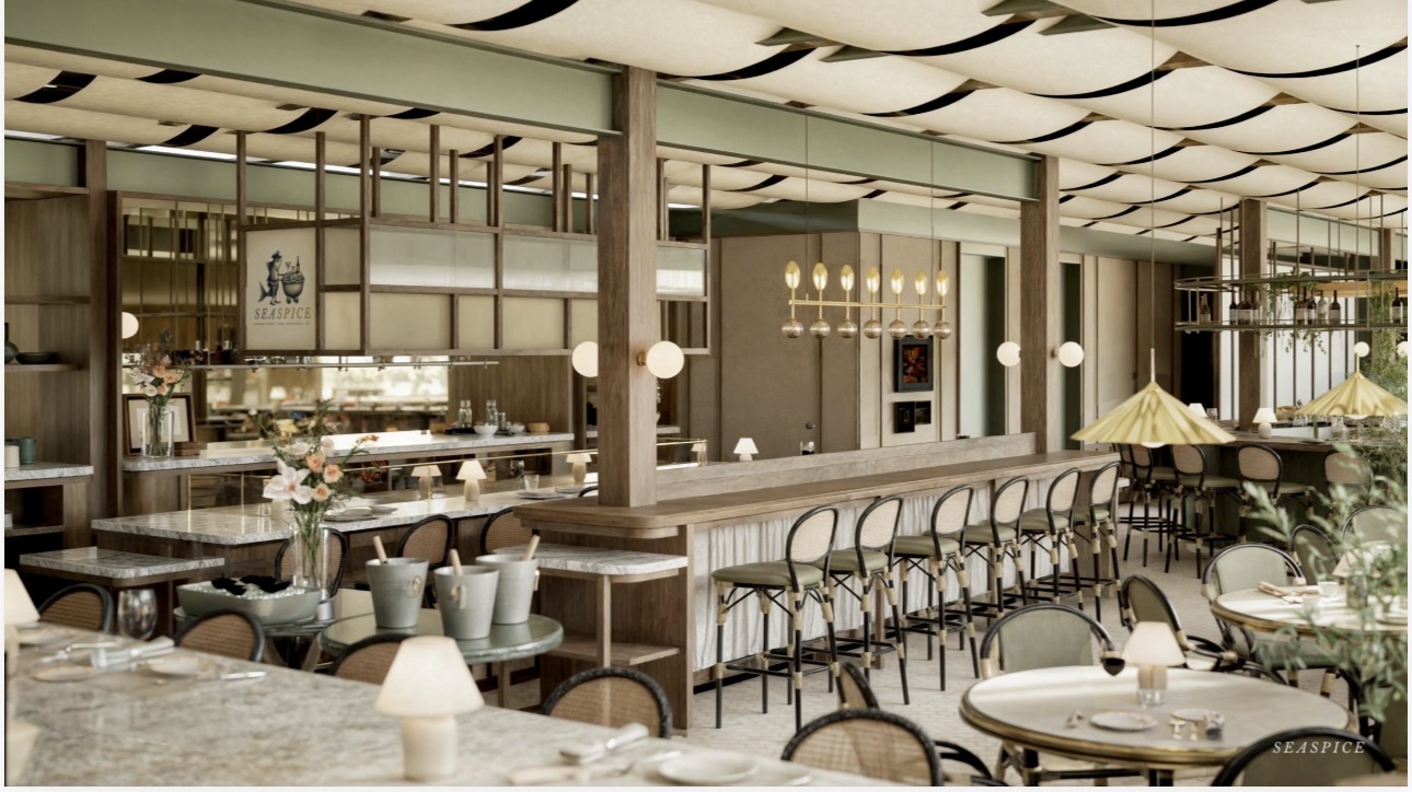Interior of a restaurant with tables, chairs, bar area, and decorative lighting, featuring a modern design with large windows.