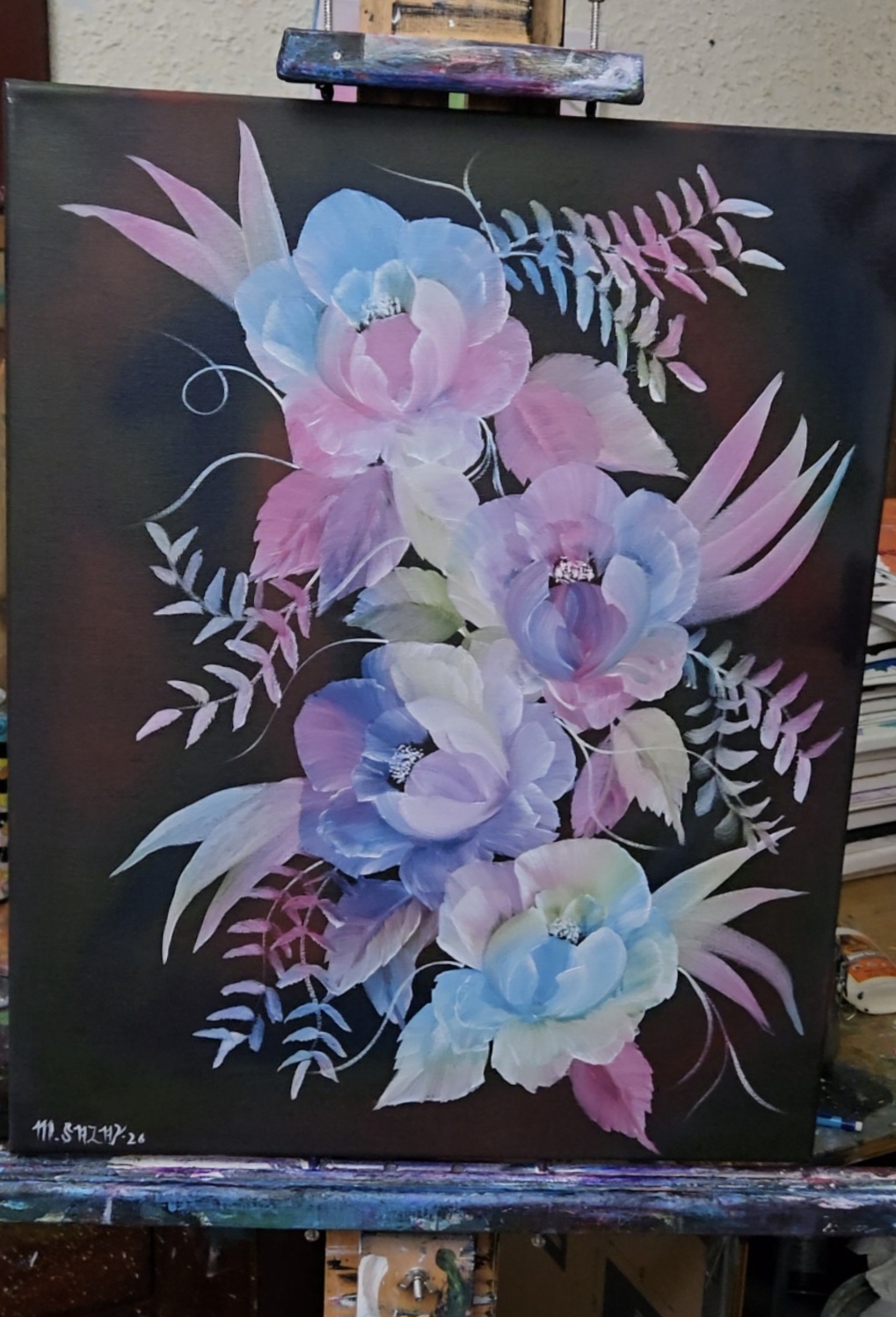 Colorful watercolor floral painting with pink, blue, and purple flowers and leaves on a dark background.