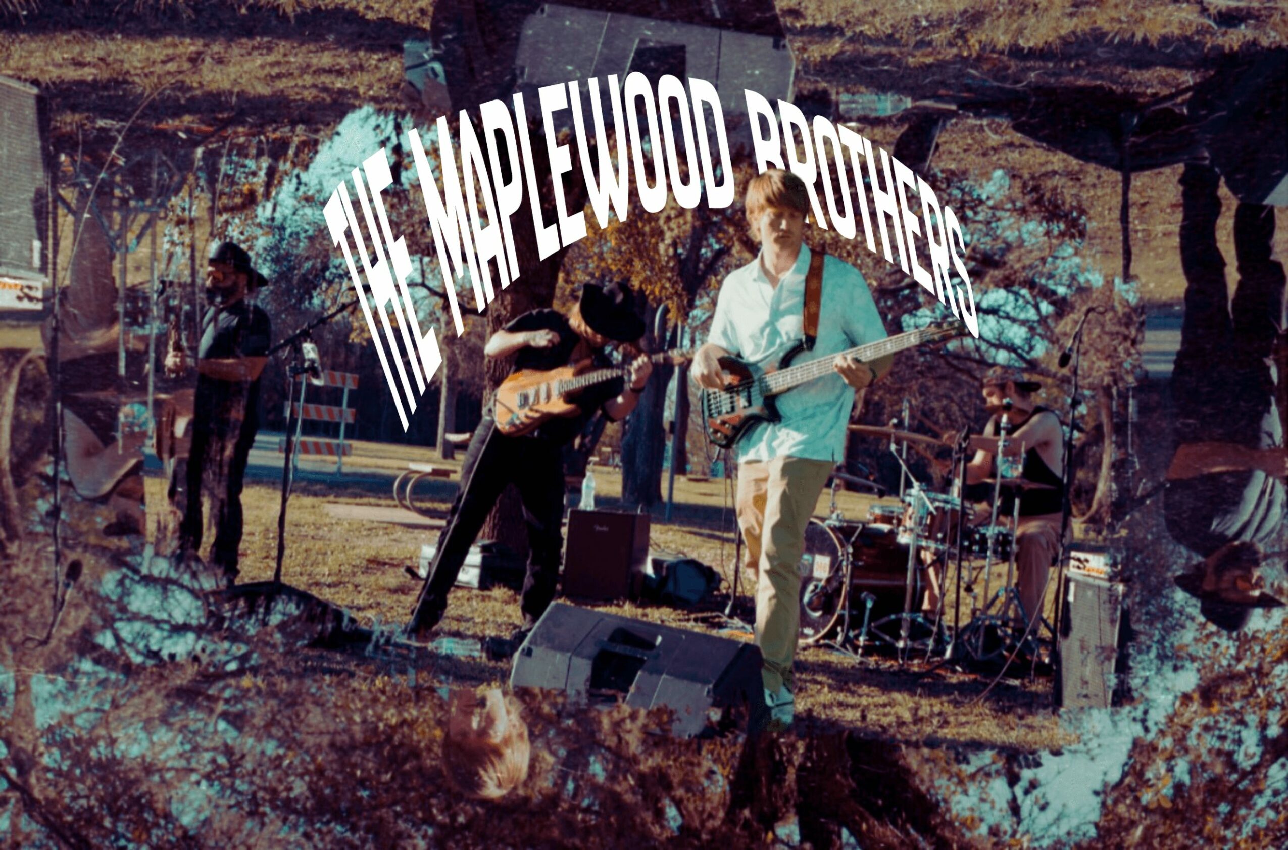 Band performing outdoors with a sign reading 'Maplewood Rovers' behind them, trees and equipment visible.