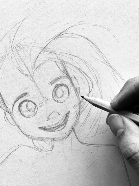 Sketch of a smiling cartoon girl with large eyes and flowing hair, being drawn with a pen.