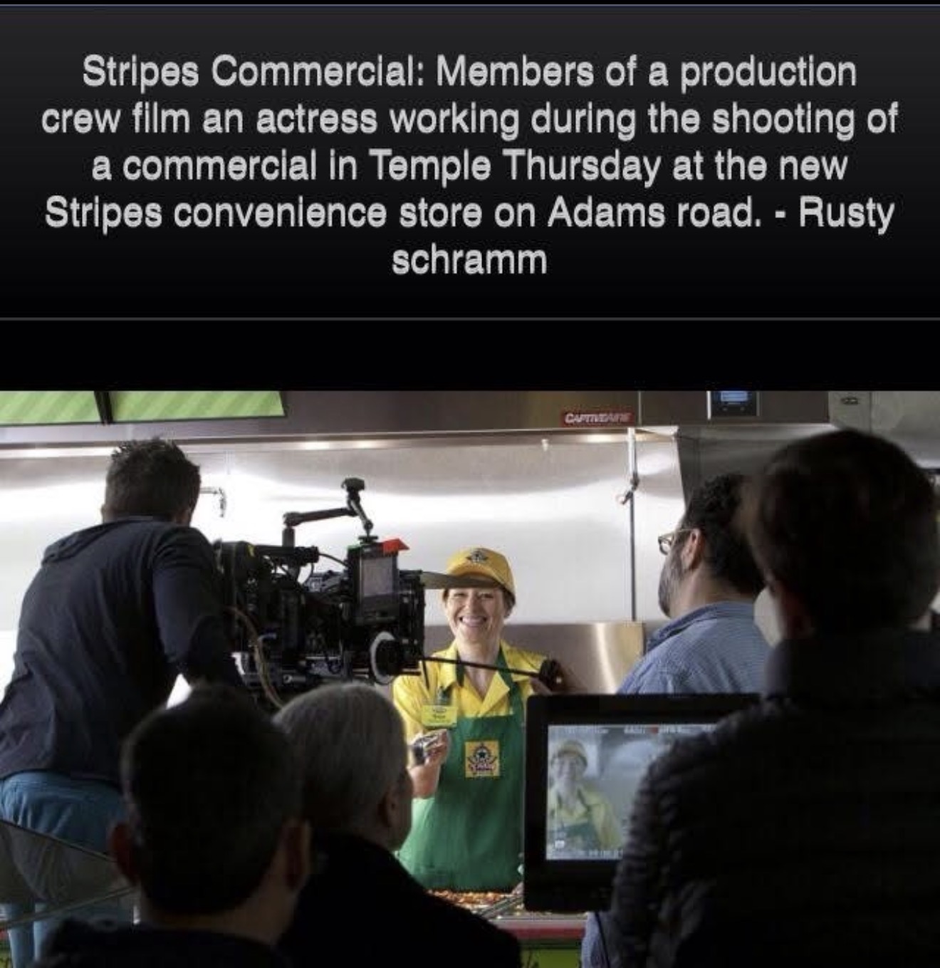 Person in yellow hat and green apron speaking in a kitchen with camera crew and monitors, behind a black text overlay.