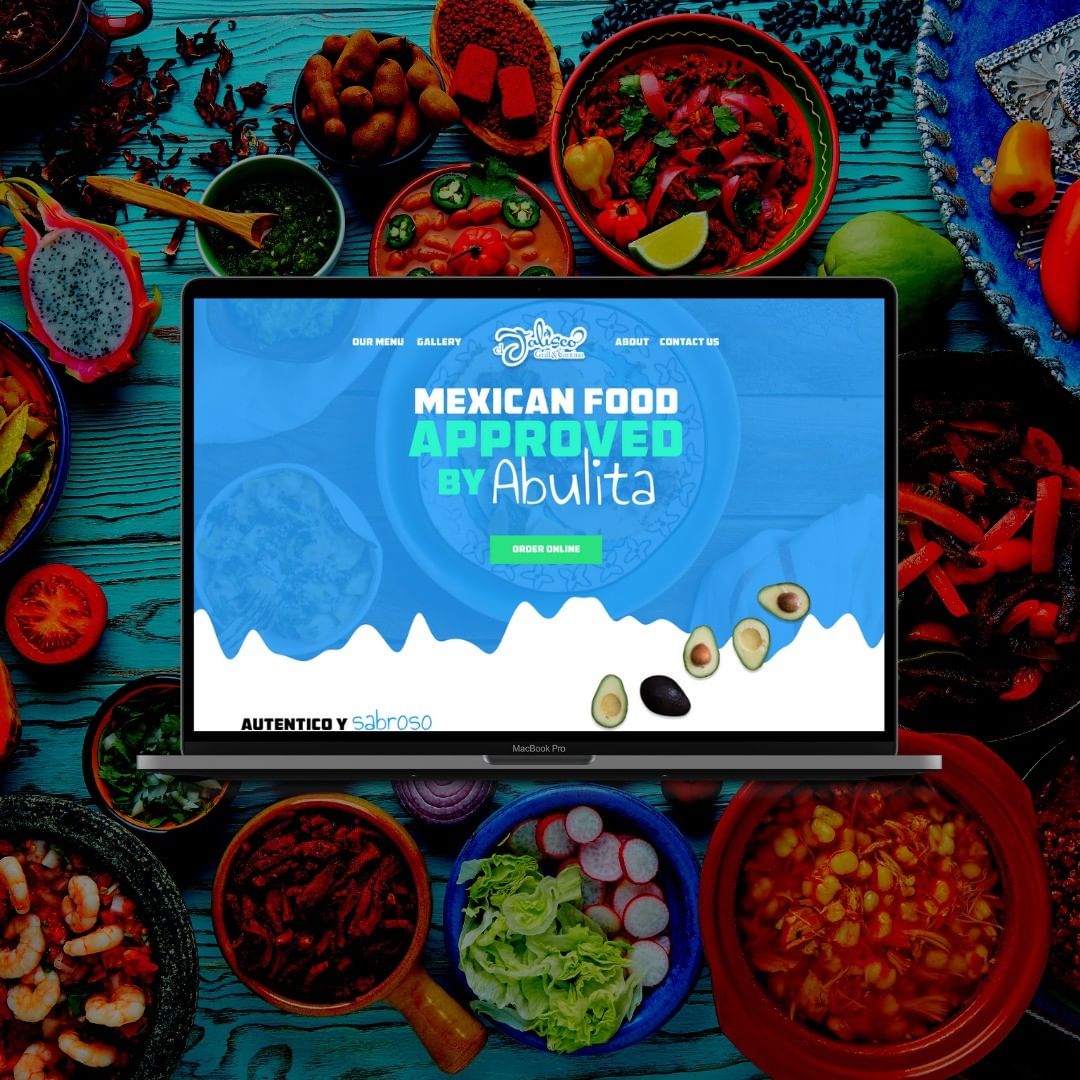 Laptop displaying Mexican food approval website surrounded by various colorful food bowls and ingredients.