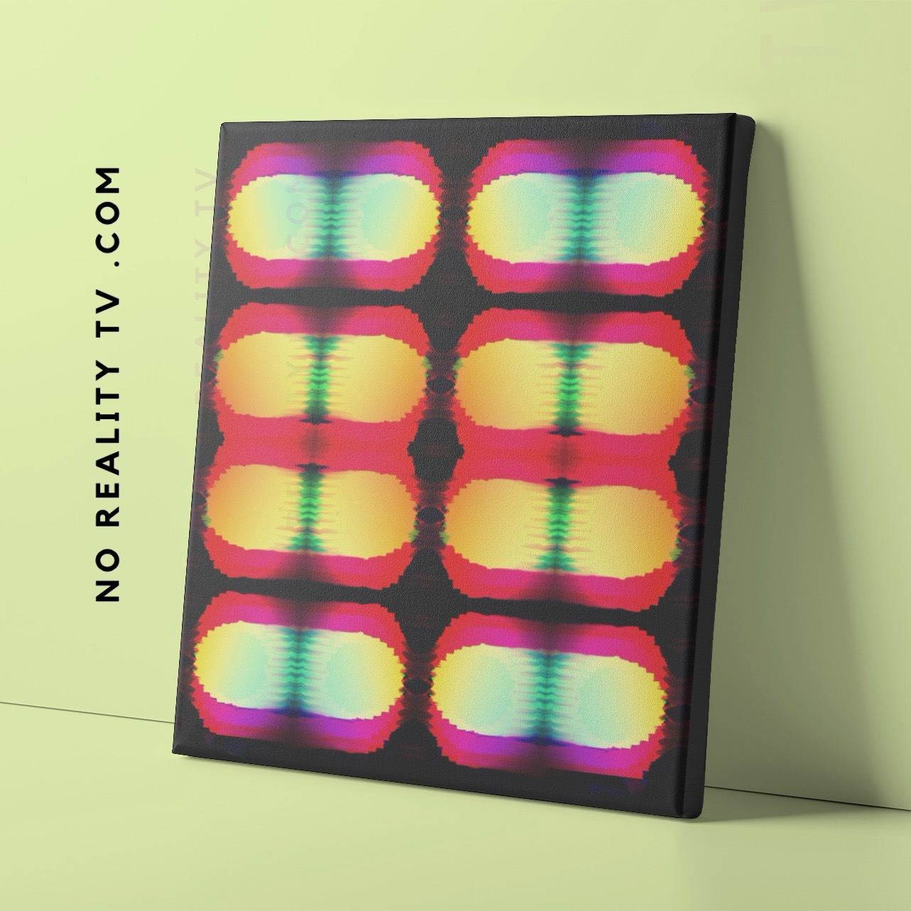 Colorful abstract artwork with symmetrical patterns on a black background, leaning against a light green wall.