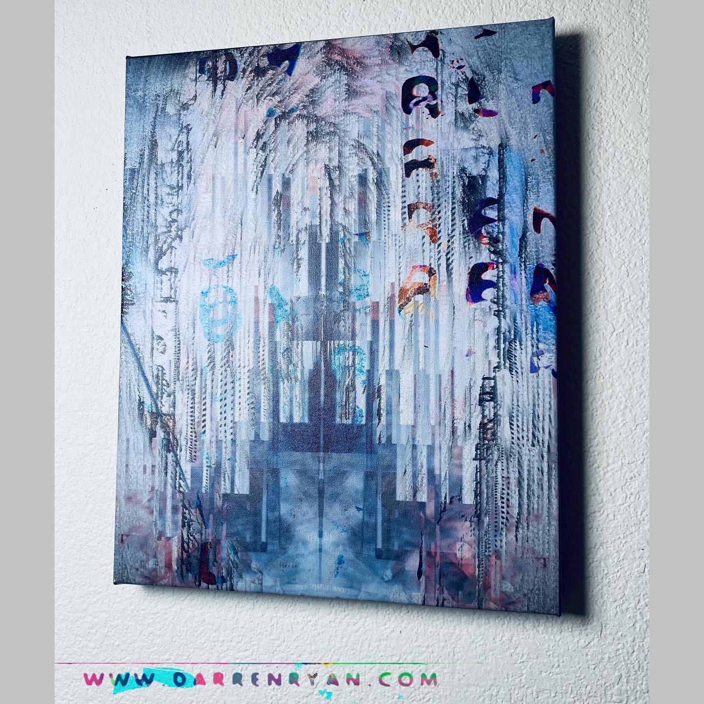 Abstract painting with blue, purple, and white colors on a wall, featuring vertical streaks and shapes.