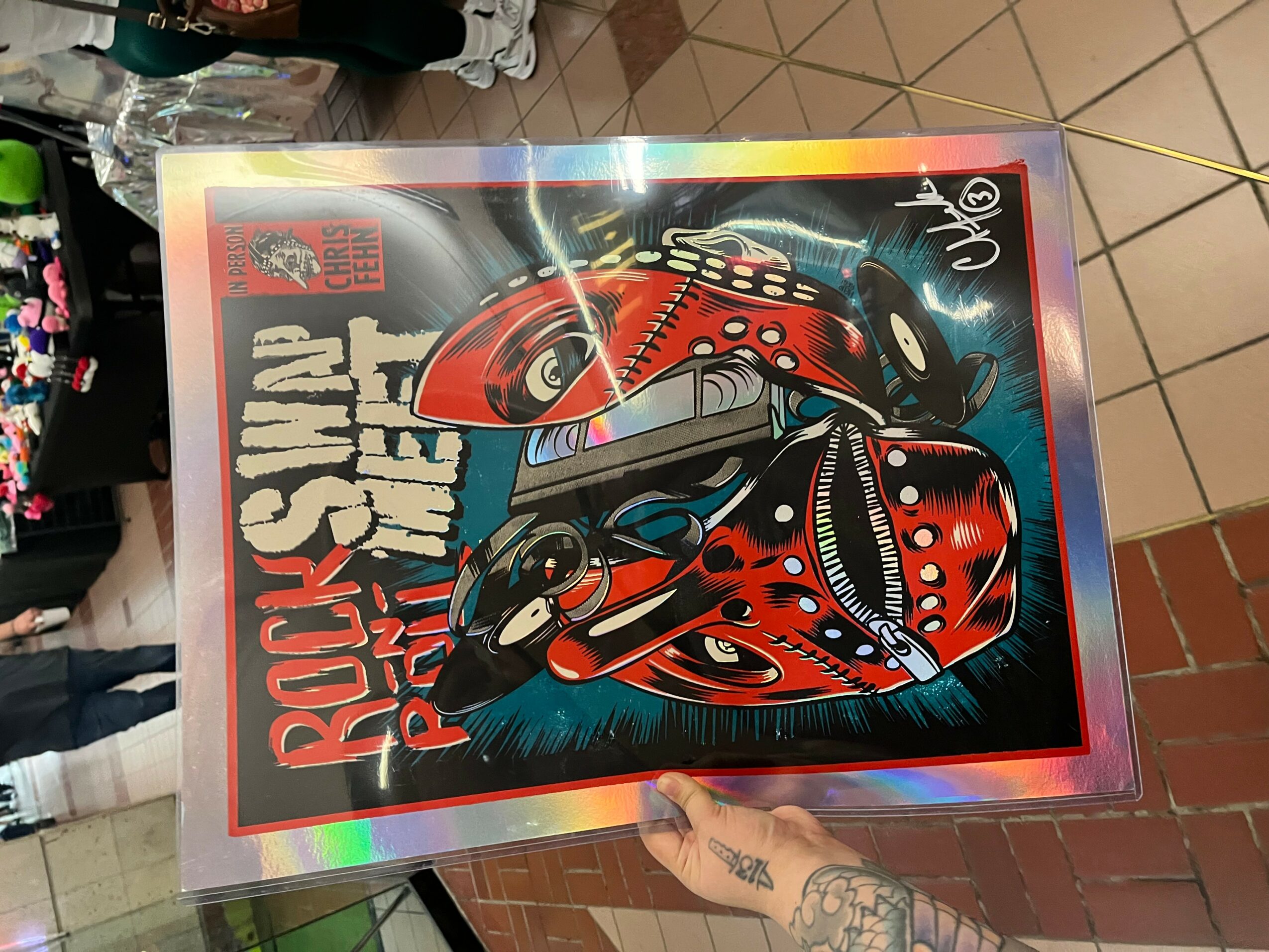 A colorful poster features a red ladybug with black spots and a robotic face, with text and a rainbow border.
