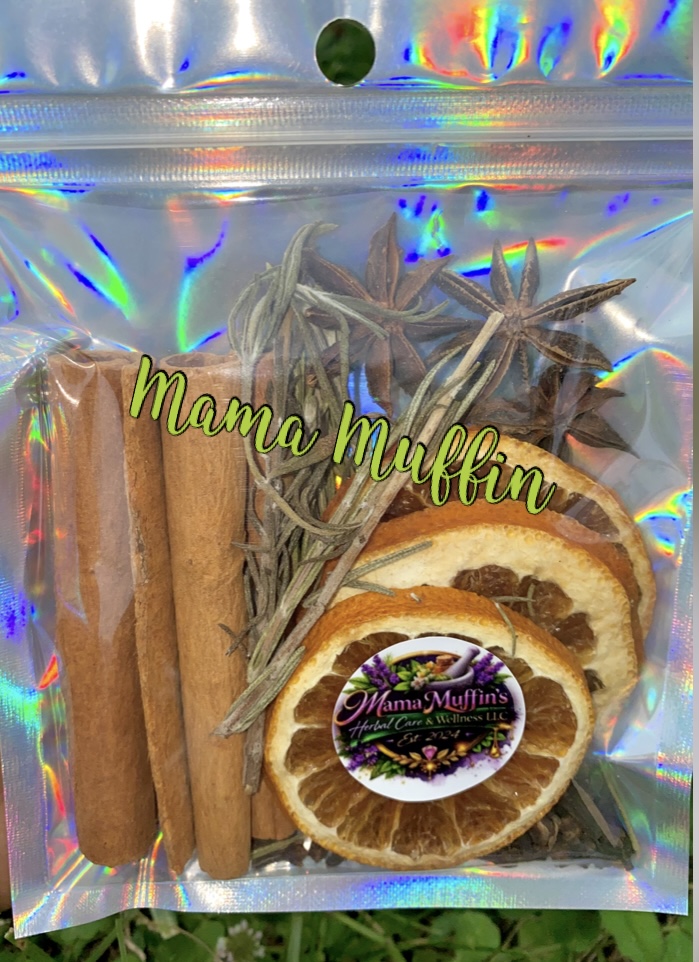 Clear plastic bag with cinnamon sticks, dried orange slices, and dried herbs, labeled 'Mama Muffin' with a colorful sticker.