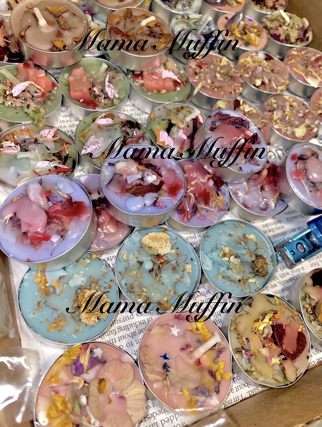 Assorted colorful muffins and cupcakes on a table with text overlay reading 'Mama's Muffin'.