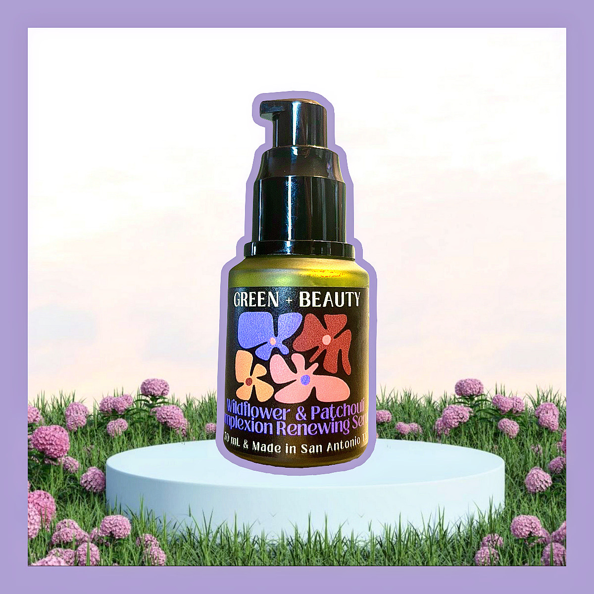Bottle of Green Beauty skincare product on a white platform with pink flowers and green grass background.