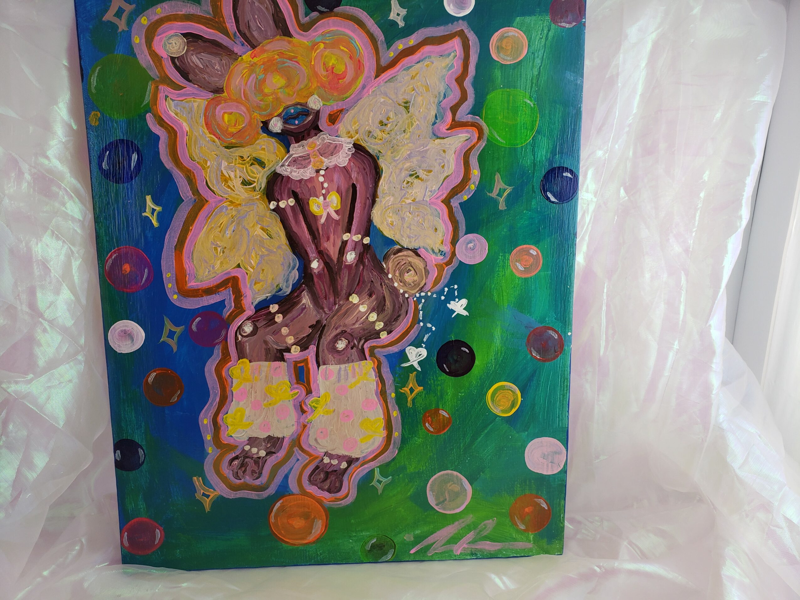 Colorful painting of a fairy with wings, surrounded by circles and stars, on a green background.