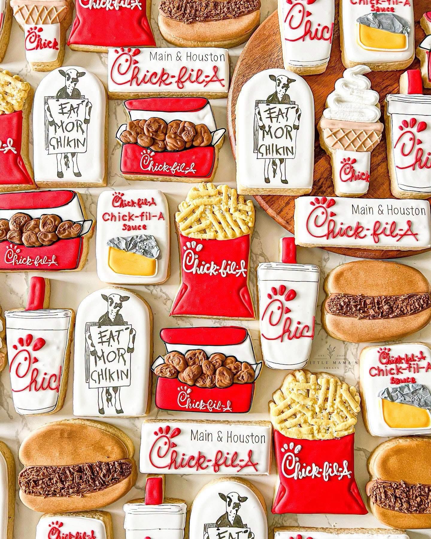 Collection of fast food items including sandwiches, fries, drinks, and desserts with Chick-fil-A branding, arranged closely together.
