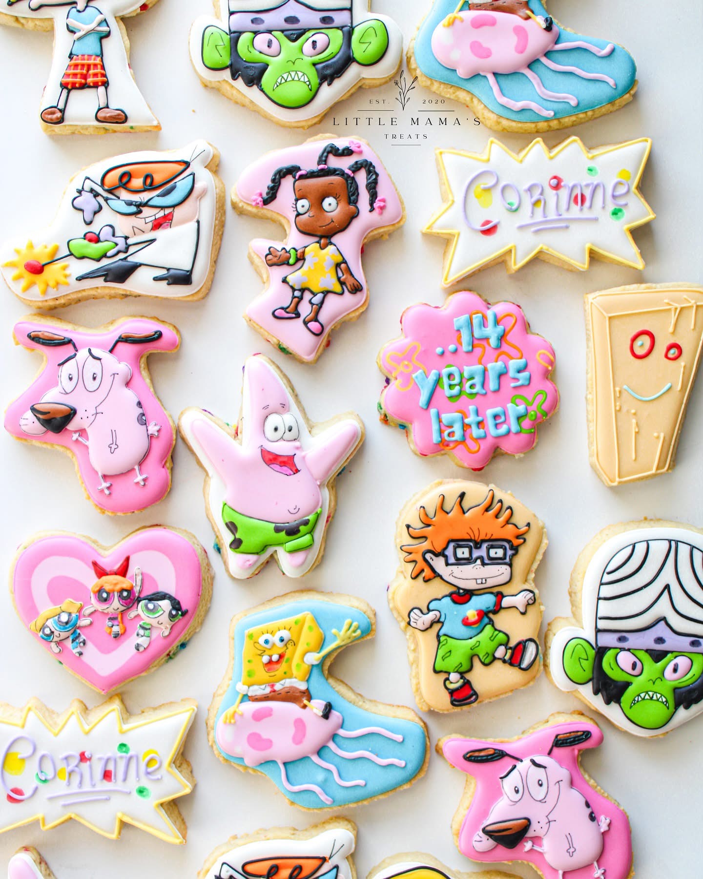 Collection of colorful cookies shaped like animals, characters, and objects, with various decorations and text, on a light background.