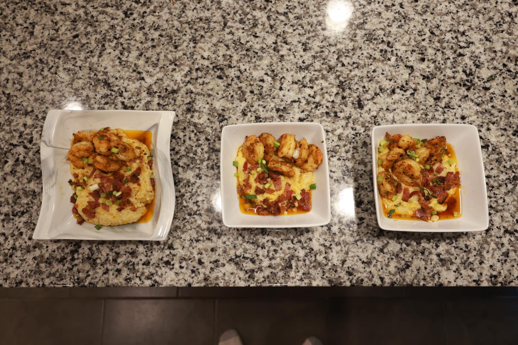 Three small plates with pizza slices on a granite countertop, each with different toppings and crusts.