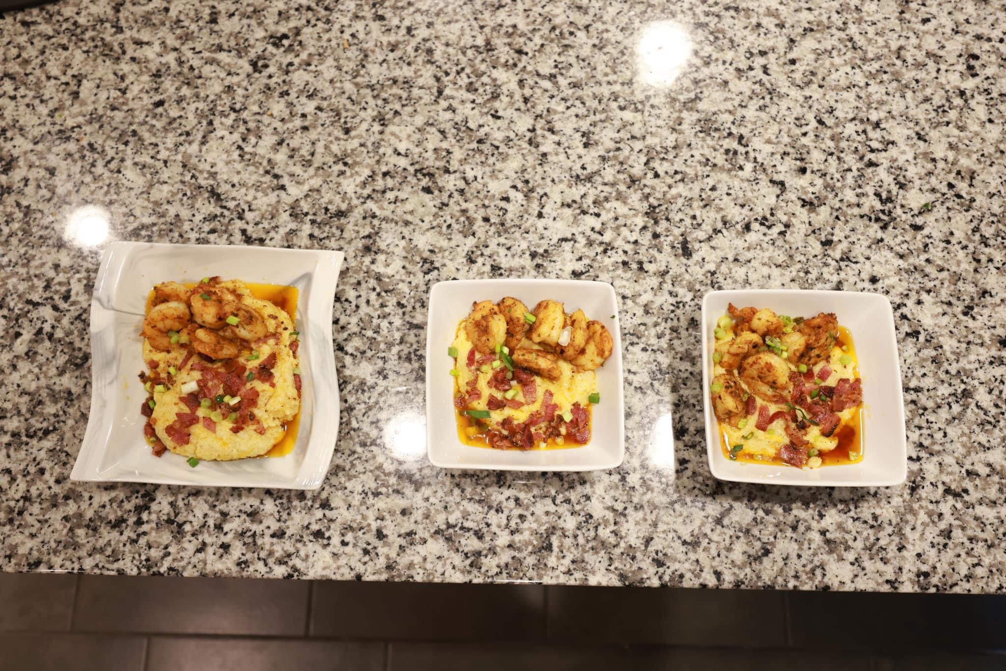Three small square dishes with food on a speckled gray countertop, one larger dish on the left, two smaller dishes on the right