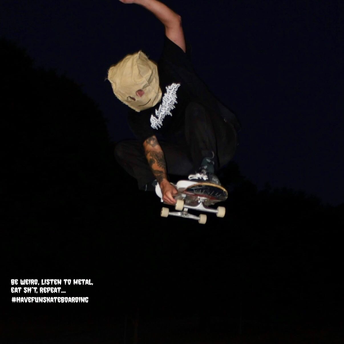 Skateboarder with blonde hair performing a trick at night, dark background, text in bottom left corner, 20 words.